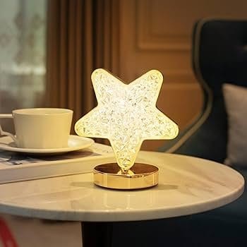 Illuminated star-shaped night light on a marble table for cozy home decor.